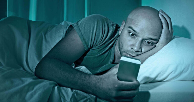 Man sleeping with his phone, Laying on bed using phone