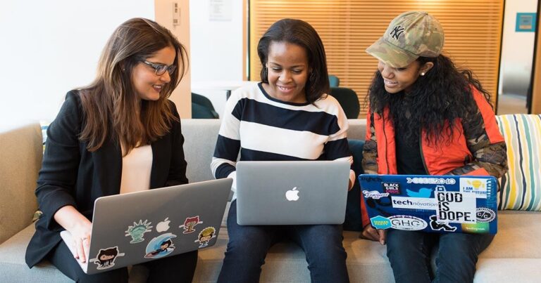 Black women with computers, 3 young girls working smiling